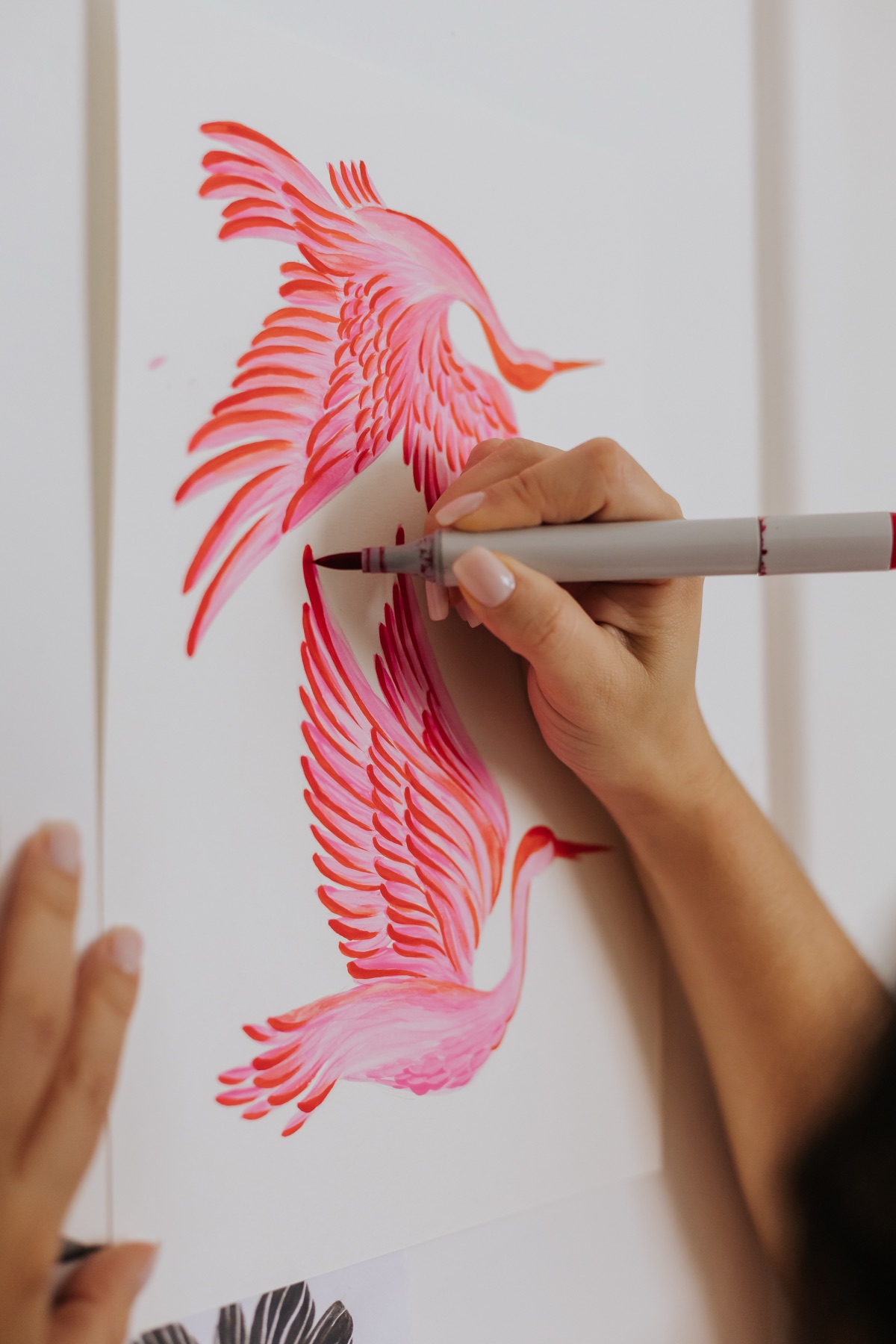 A crane motif being painted by hand